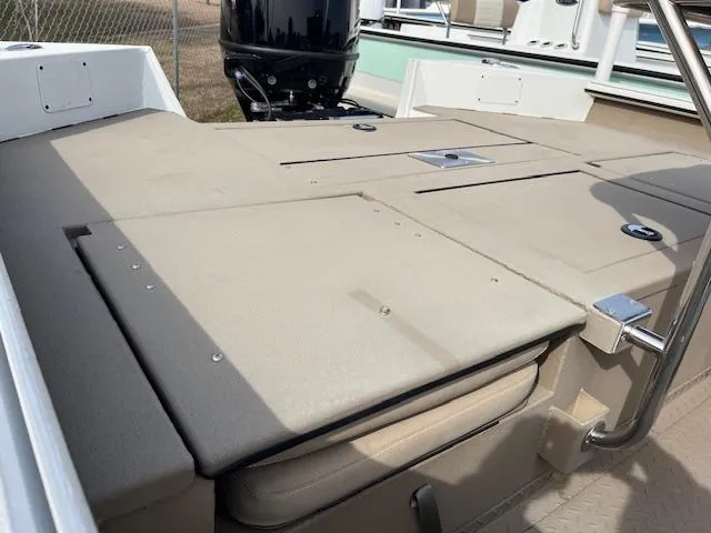 Slide: The Image of 2023 SeaArk Bayrunner 210 boat deck with storage compartments and motor. - 6