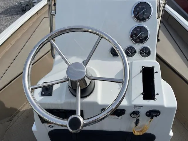 Slide: The Image of 2023 SeaArk Bayrunner 210 boat console with steering wheel and gauges. - 7