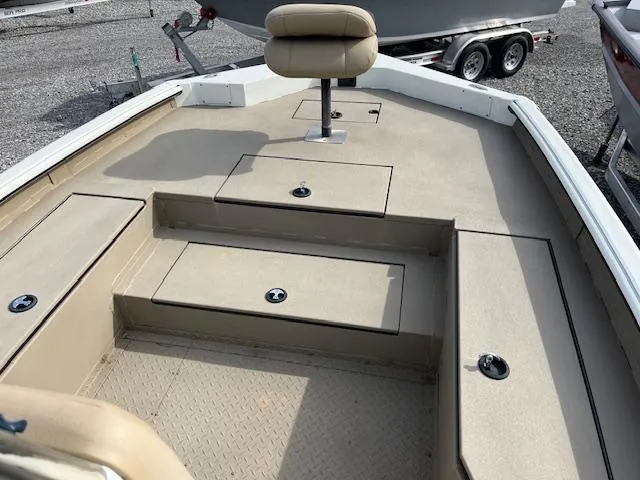 Slide: The Image of 2023 SeaArk Bayrunner 210 boat interior with seating and storage compartments. - 8