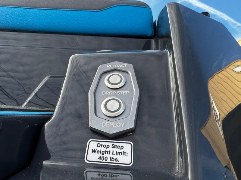 Slide: The Image of 2025 Supra SE 550 boat control panel with drop step buttons and weight limit label. - 10