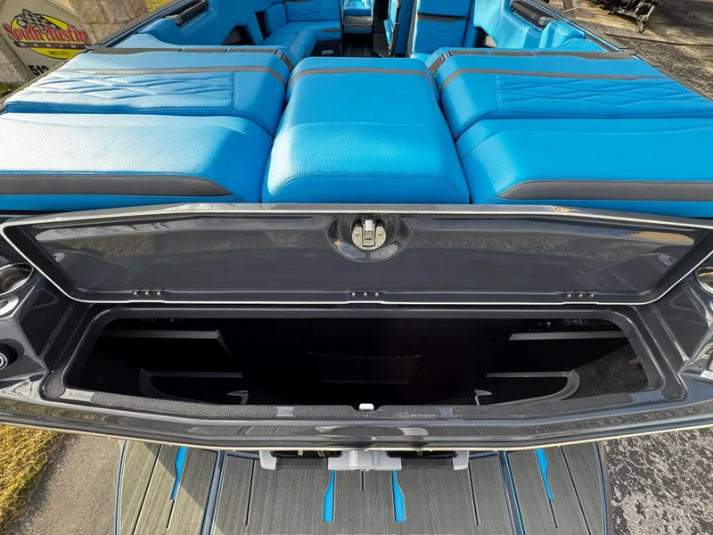 Slide: The Image of 2025 Supra SE 550 boat with blue seating and open storage compartment. - 13