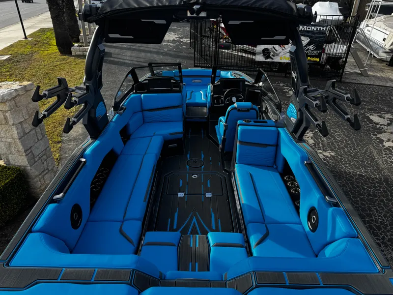 Slide: The Image of 2025 Supra SE 550 boat interior with vibrant blue seating and sleek design. - 14