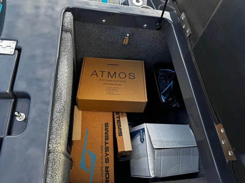 Slide: The Image of Storage compartment of 2025 Supra SE 550 with various boxes and accessories. - 18