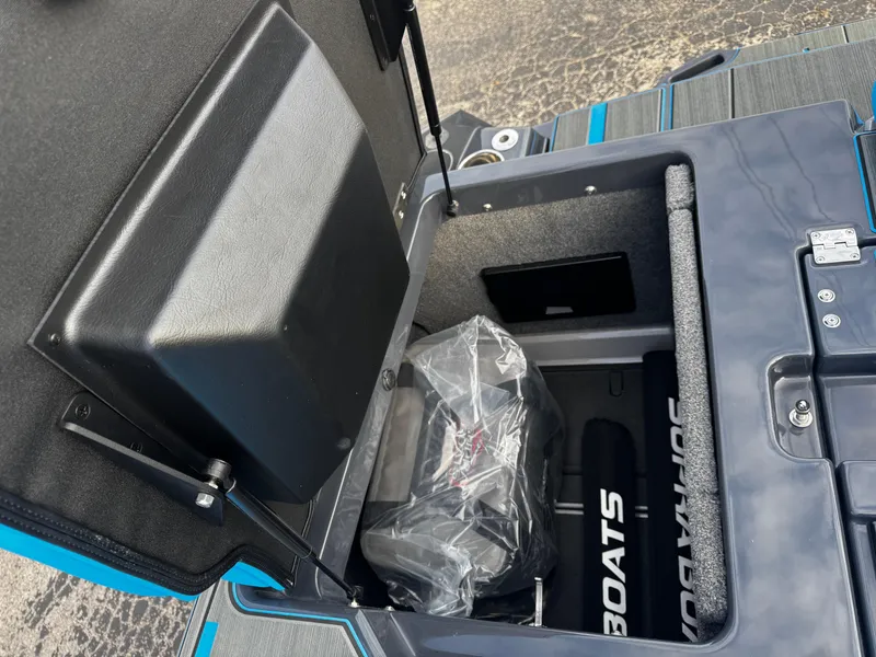 Slide: The Image of 2025 Supra SE 550 boat storage compartment with open lid, showcasing interior space. - 19