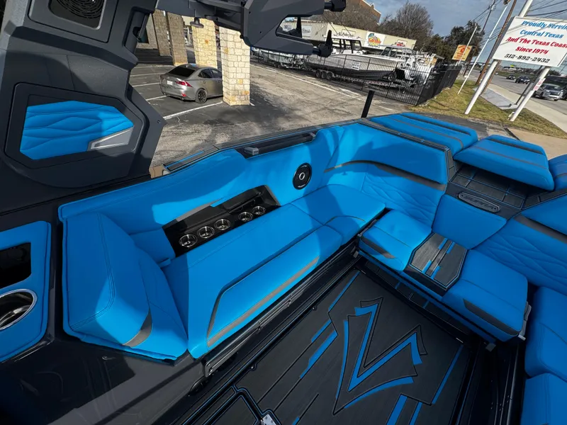 Slide: The Image of 2025 Supra SE 550 boat interior with vibrant blue seating and sleek design. - 22