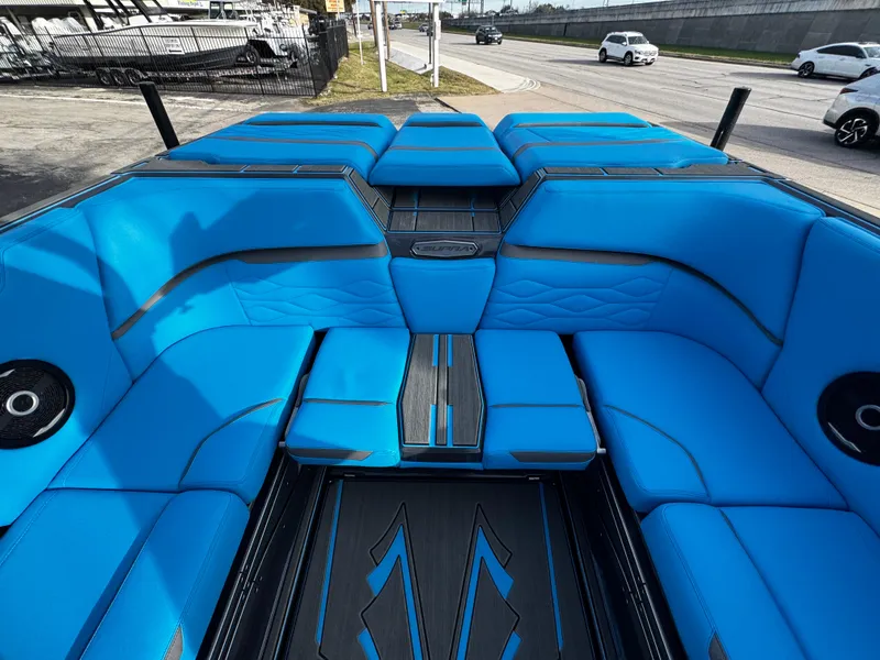 Slide: The Image of 2025 Supra SE 550 boat interior with vibrant blue seating and sleek design. - 23