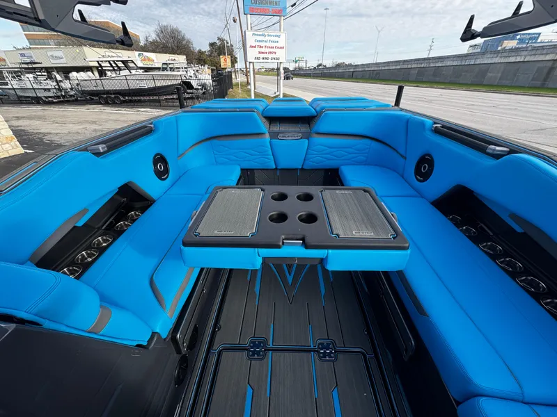 Slide: The Image of 2025 Supra SE 550 boat interior with vibrant blue seating and sleek design. - 28
