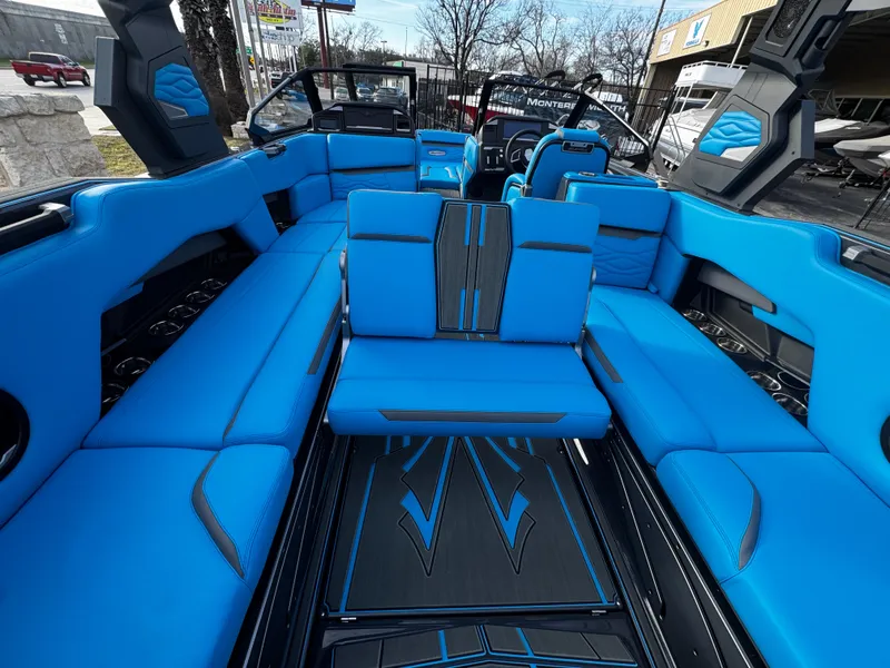 Slide: The Image of 2025 Supra SE 550 boat interior with vibrant blue seating and sleek design. - 29