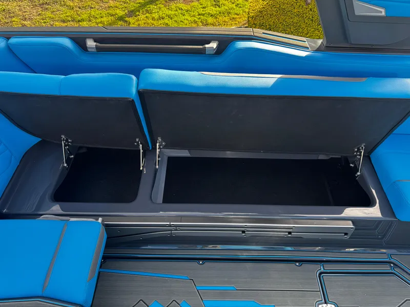 Slide: The Image of 2025 Supra SE 550 boat interior with open blue storage compartments. - 30