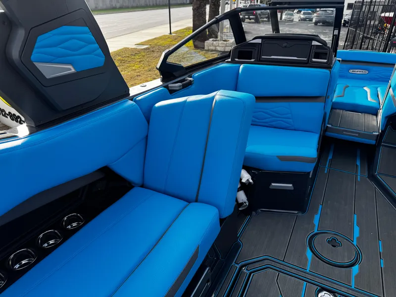 Slide: The Image of 2025 Supra SE 550 boat interior with blue seating and modern design. - 31