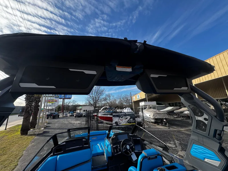 Slide: The Image of 2025 Supra SE 550 boat interior with blue seating and modern dashboard under a clear sky. - 41