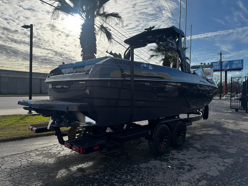 Slide: The Image of 2025 Supra SE 550 boat on trailer under cloudy sky. - 7
