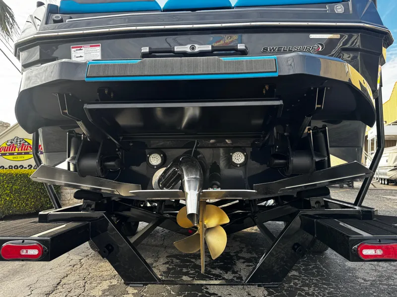 Slide: The Image of 2025 Supra SE 550 boat rear view with propeller and wakeboard features. - 8