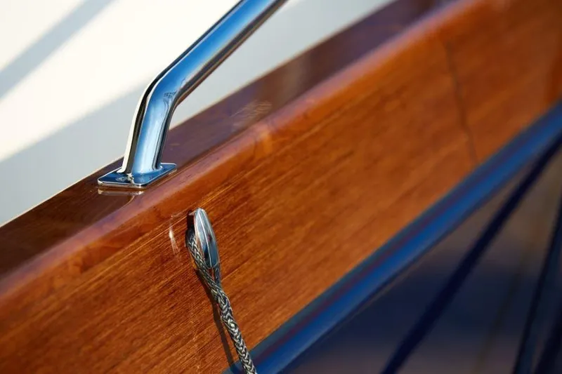 Slide: The Image of Close-up of 2025 Rustler 41 yacht's polished wood and metal railing. - 16