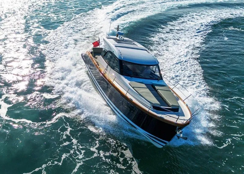 Slide: The Image of 2025 Rustler 41 yacht cruising on open water, creating dynamic waves. - 2