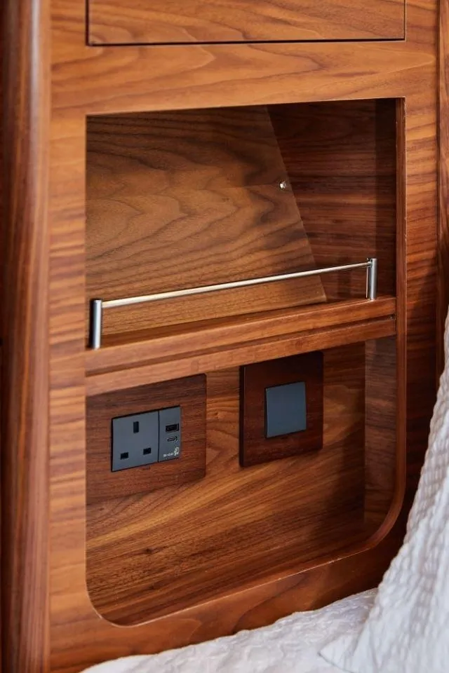 Slide: The Image of Wooden interior detail of 2025 Rustler 41 yacht with power outlet and switch. - 27