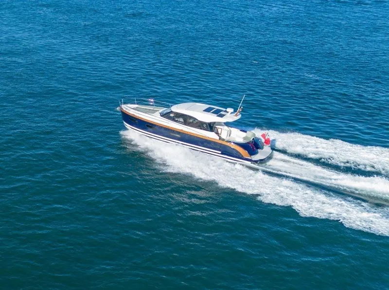 Slide: The Image of 2025 Rustler 41 yacht cruising on open blue water. - 3