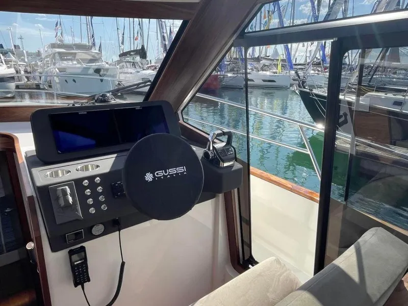 Slide: The Image of 2025 Rustler 41 yacht cockpit with Gussi steering wheel, marina view, and modern controls. - 31