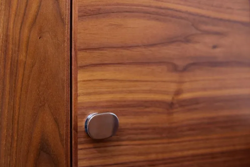 Slide: The Image of Wooden cabinet door with a sleek metal knob, Rustler 41, 2025 model. - 33