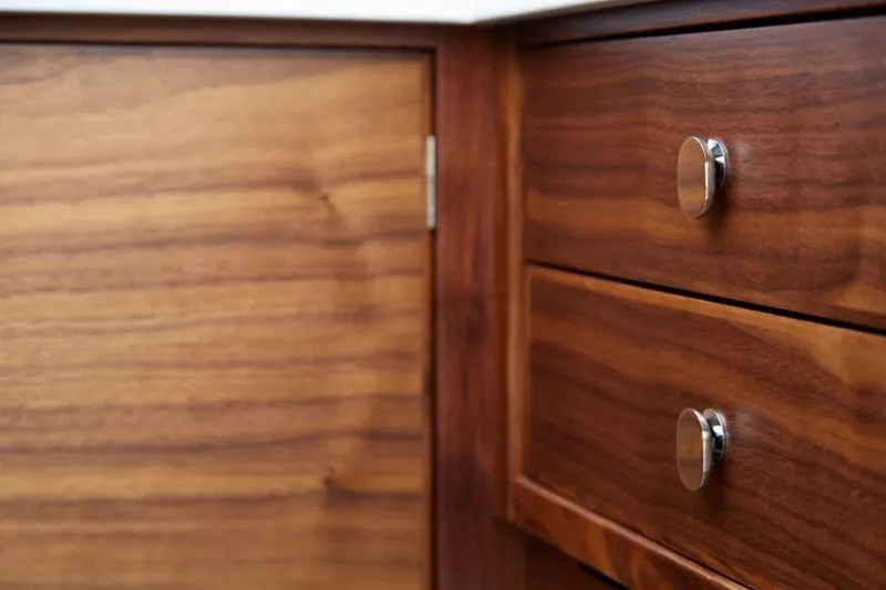 Slide: The Image of Wooden cabinet with drawers and silver knobs, Rustler 41, 2025 model. - 34