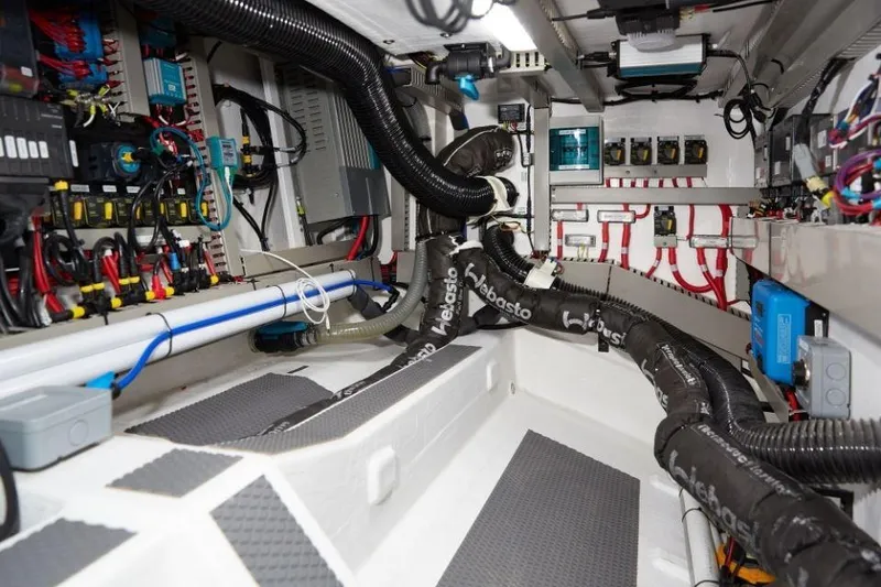 Slide: The Image of Engine room of 2025 Rustler 41 yacht with complex wiring and ventilation systems. - 42