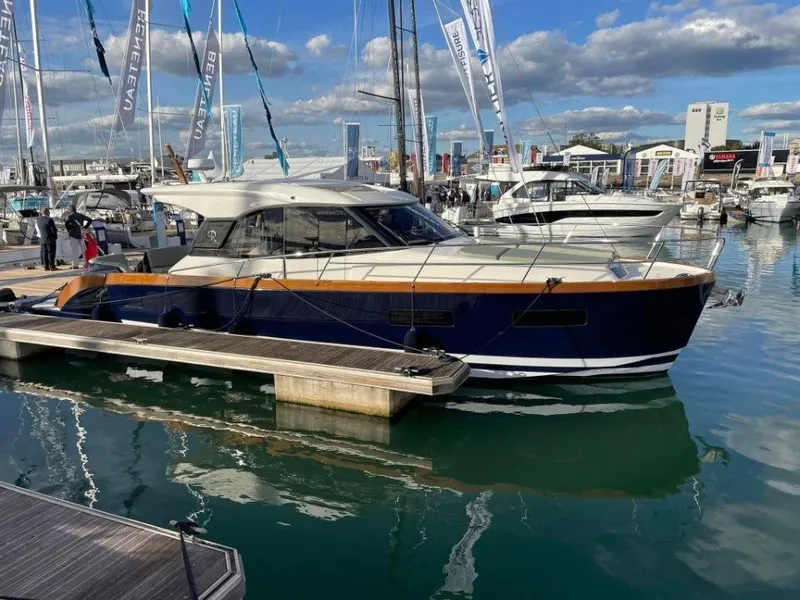 Slide: The Image of 2025 Rustler 41 yacht docked at marina, surrounded by other boats under a partly cloudy sky. - 7
