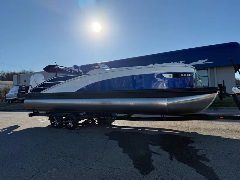 Slide: The Image of 2024 Bennington RX Sport Line boat on trailer under bright sun. - 0