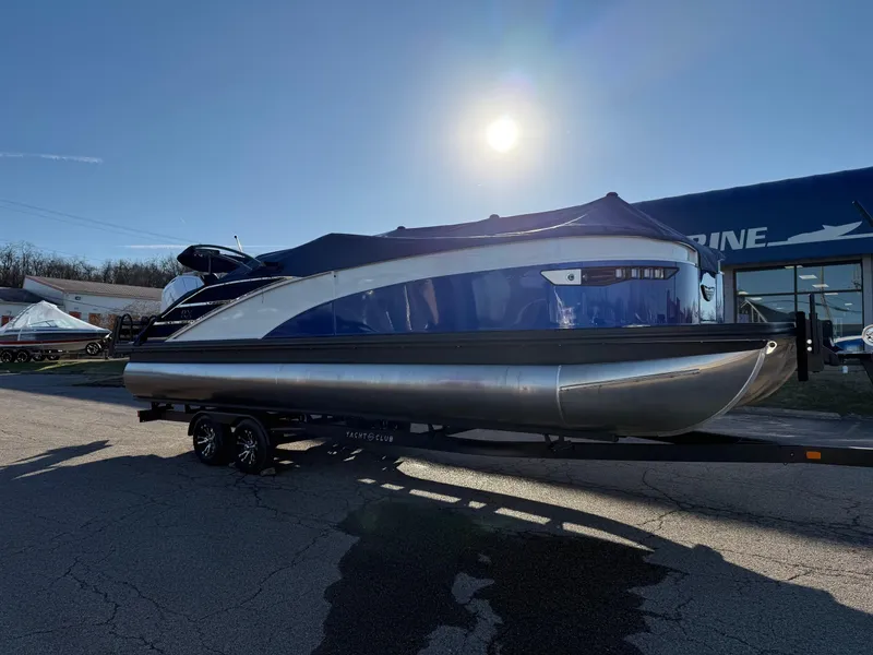 Slide: The Image of 2024 Bennington RX Sport Line pontoon boat on trailer under bright sun. - 1