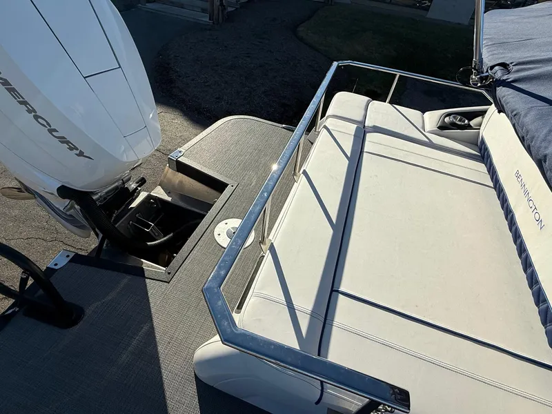 Slide: The Image of 2024 Bennington RX Sport Line boat with Mercury engine, featuring a sleek rear seating area. - 11
