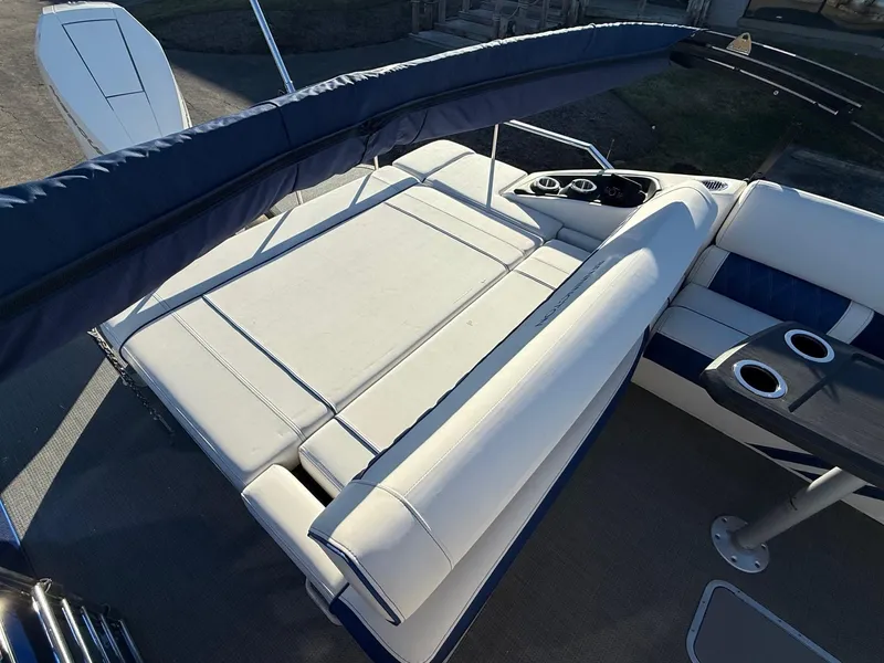 Slide: The Image of 2024 Bennington RX Sport Line boat interior with white seating and cup holders. - 12