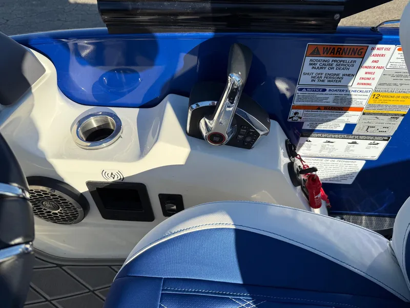 Slide: The Image of 2024 Bennington RX Sport Line boat console with controls and warning labels. - 14