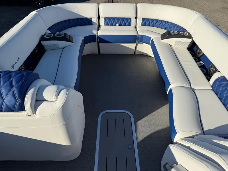 Slide: The Image of 2024 Bennington RX Sport Line boat interior with blue and white seating and cup holders. - 15