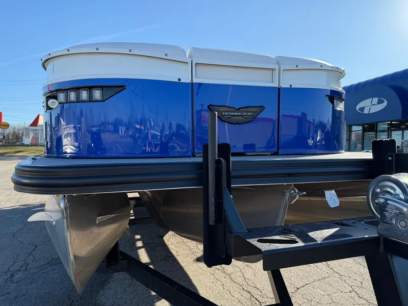 Slide: The Image of 2024 Bennington RX Sport Line pontoon boat with blue exterior on a trailer. - 16