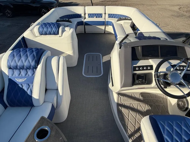 Slide: The Image of 2024 Bennington RX Sport Line boat interior with blue and white seating. - 2