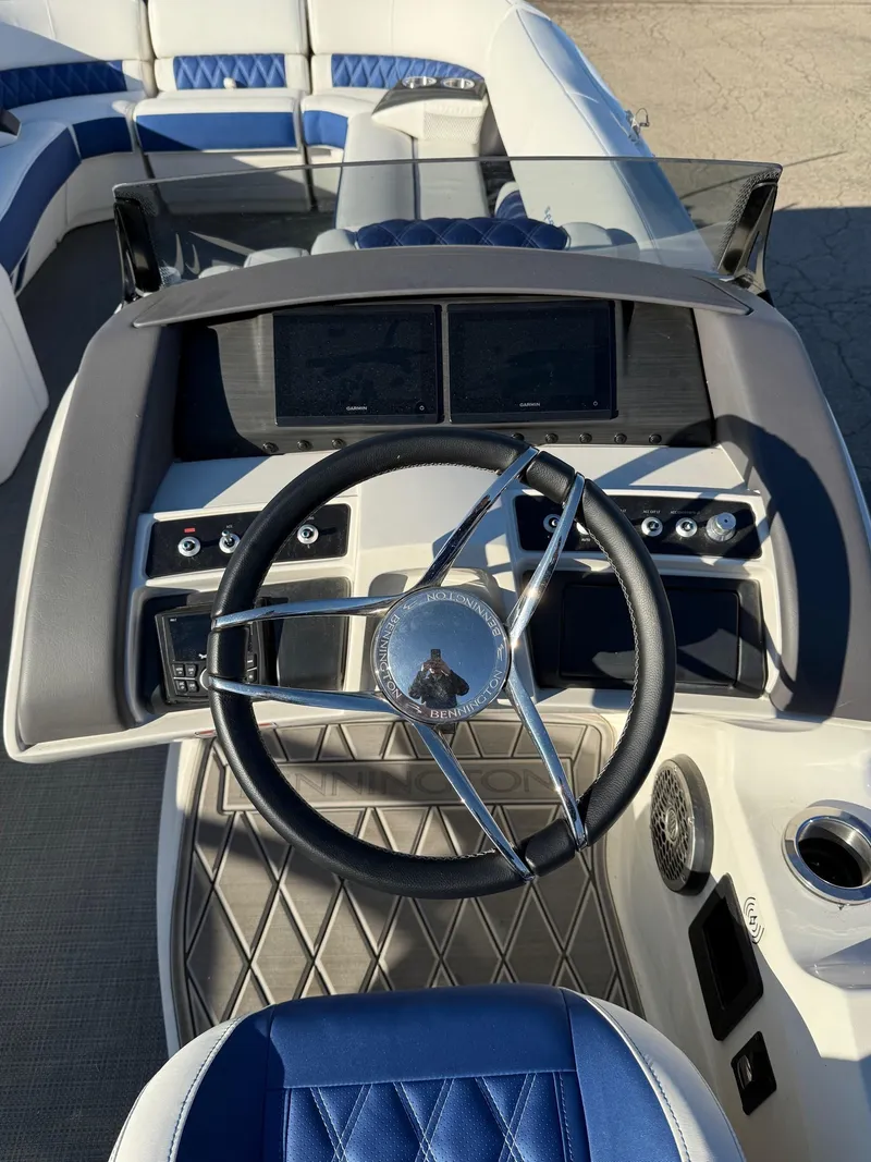 Slide: The Image of 2024 Bennington RX Sport Line boat dashboard with steering wheel and controls. - 5