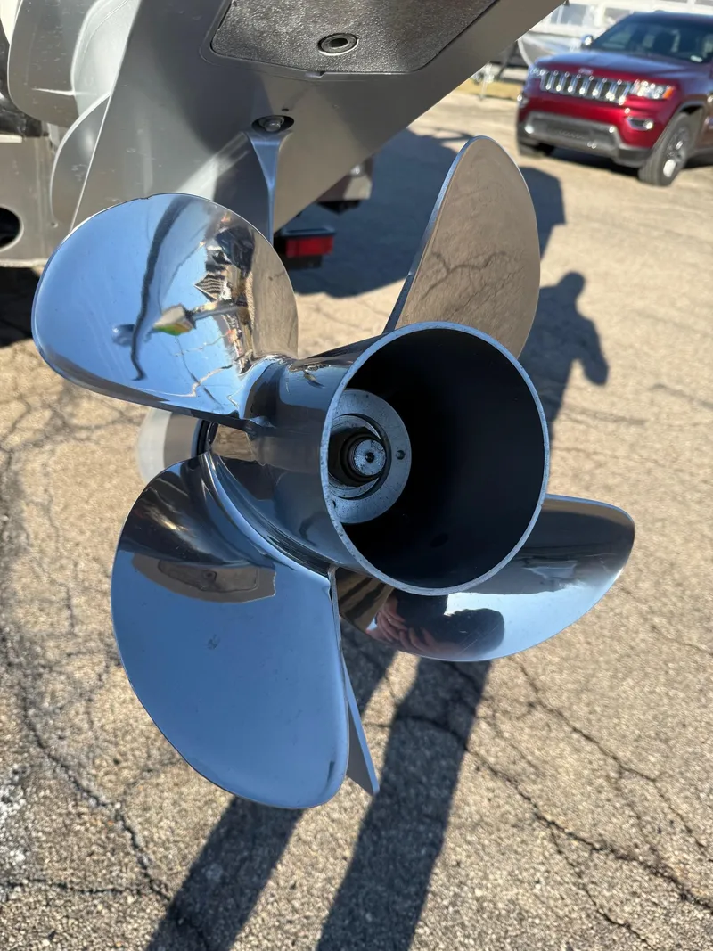 Slide: The Image of 2024 Bennington RX Sport Line boat propeller, shiny metal finish, outdoor setting. - 9