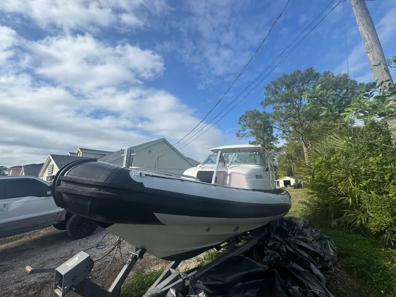 Slide: The Image of 2002 Protector 28 Targa boat on trailer under blue sky. - 2