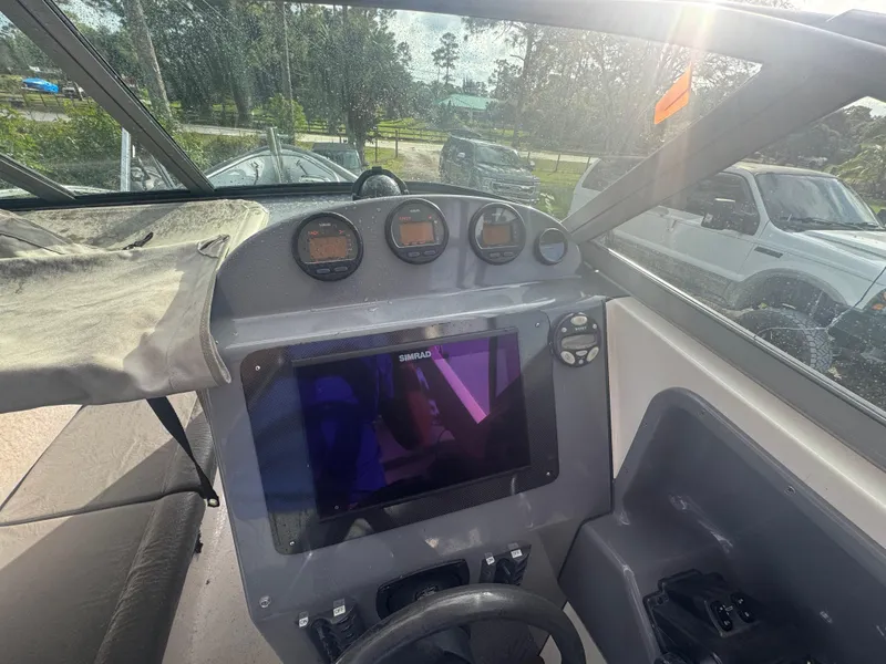Slide: The Image of 2002 Protector 28 Targa boat dashboard with gauges and navigation screen. - 5