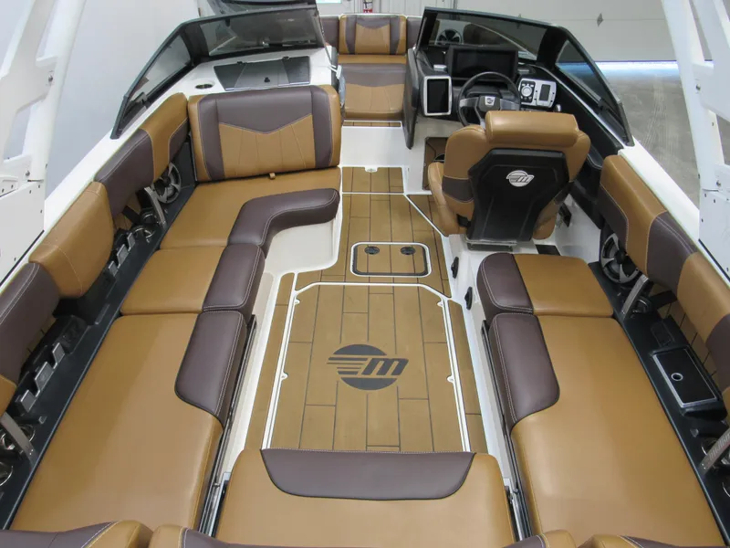 Slide: The Image of 2020 Malibu Wakesetter 23 MXZ interior with brown and black seating, modern dashboard. - 4