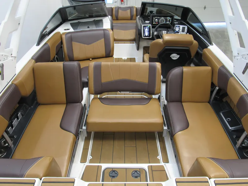 Slide: The Image of 2020 Malibu Wakesetter 23 MXZ interior with brown and tan seating, modern dashboard. - 5
