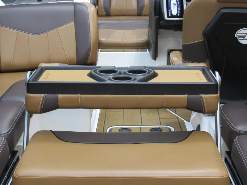 Slide: The Image of 2020 Malibu Wakesetter 23 MXZ interior with brown leather seats and cup holders. - 6