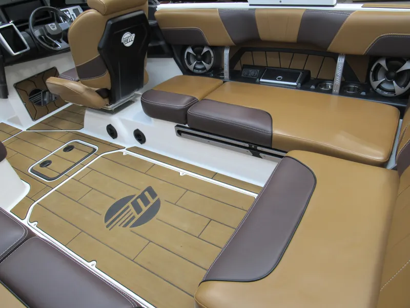 Slide: The Image of 2020 Malibu Wakesetter 23 MXZ interior with brown and black seating, stylish flooring. - 7