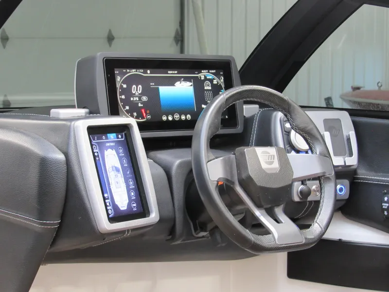 Slide: The Image of 2020 Malibu Wakesetter 23 MXZ dashboard with digital displays and steering wheel. - 9
