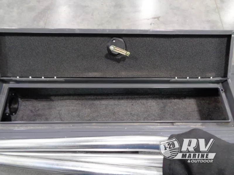 Slide: The Image of Open storage compartment of 2018 Targa V-18 WT boat, featuring lock mechanism. - 19