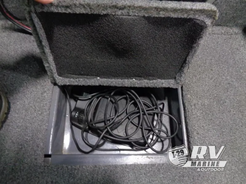 Slide: The Image of Open storage compartment in 2018 Targa V-18 WT boat with coiled cables inside. - 9