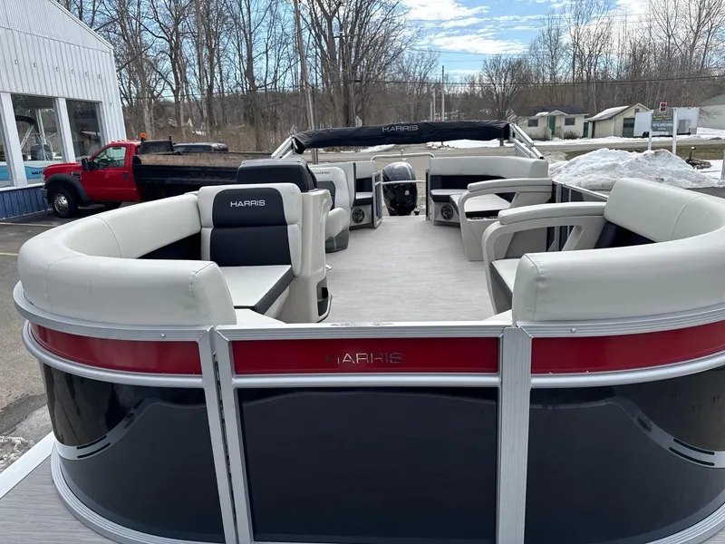 Slide: The Image of 2025 Harris Breeze 230 pontoon boat with spacious seating and modern design. - 3