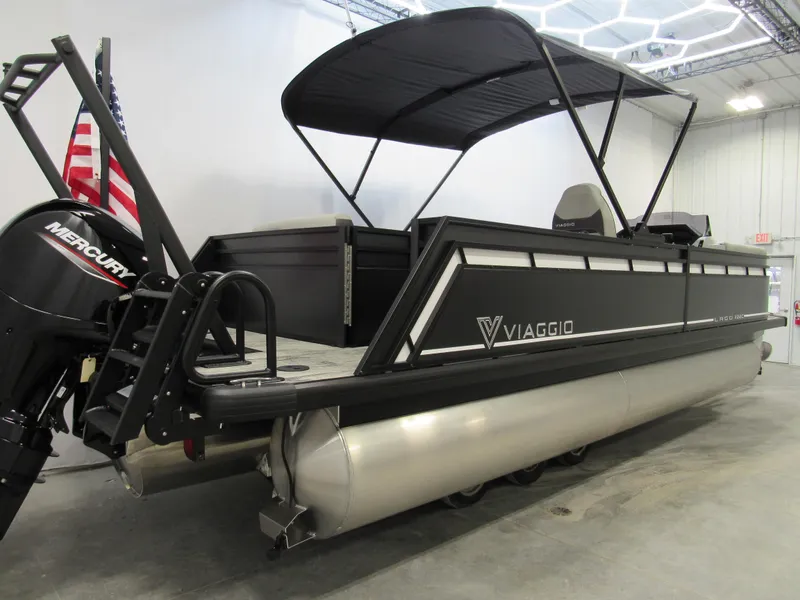 Slide: The Image of 2025 Viaggio Lago X22C pontoon boat with Mercury engine in showroom. - 2