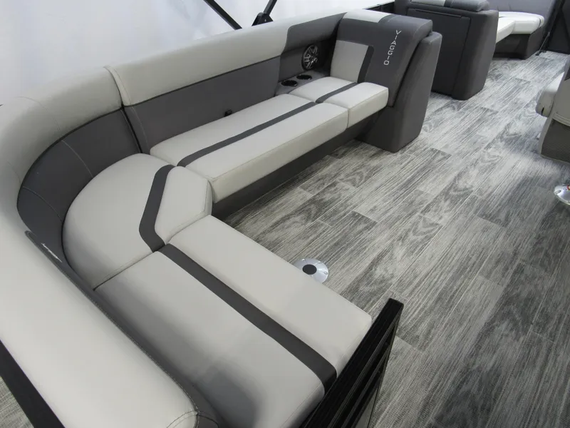 Slide: The Image of 2025 Viaggio Lago X22C boat interior with modern gray seating and wood-style flooring. - 4