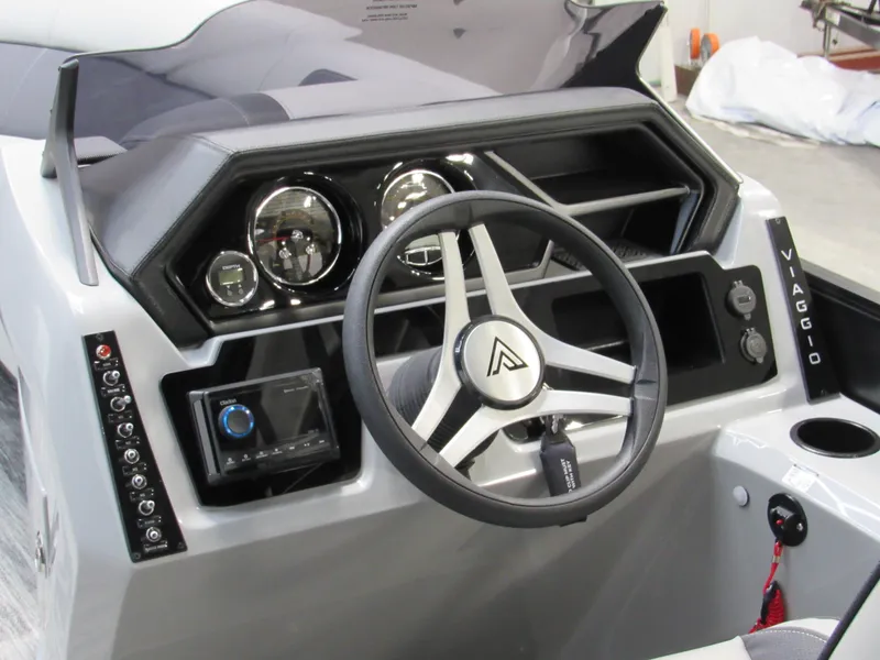 Slide: The Image of 2025 Viaggio Lago X22C boat dashboard with modern steering wheel and controls. - 5
