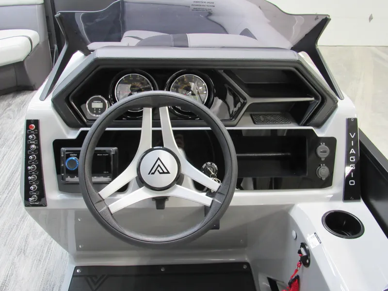 Slide: The Image of 2025 Viaggio Lago X22C boat dashboard with steering wheel and control panel. - 6